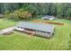 Aerial view of a ranch house with a large backyard and surrounding woods at 520 Cromer Rd, Salisbury, NC 28146