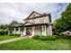 Two-story house featuring a wraparound porch and landscaping at 102 2Nd Sw St # 1, Catawba, NC 28609