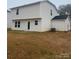 Back view of a two-story home with a small grassy backyard at 106 Plaster Ave, Shelby, NC 28152