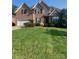 Brick home with a two-car garage and lush lawn at 5417 Spindle Ridge Ln, Gastonia, NC 28056