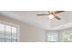 Bright bedroom featuring a ceiling fan and multiple windows at 4624 Pebble Run Dr, Matthews, NC 28105