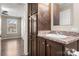 Bathroom with vanity, dark wood cabinets and view into bedroom at 115 Crystal Bay Dr, Mooresville, NC 28115