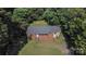 Brick ranch house with a large backyard, nestled amongst lush trees at 146 N Sutton Rd, Fort Mill, SC 29708