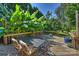 Outdoor deck with table and chairs, surrounded by greenery at 118 Broadbill Dr, Mooresville, NC 28117