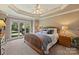 Main bedroom with tray ceiling and carpeted floors at 118 Broadbill Dr, Mooresville, NC 28117