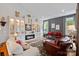 Elegant living room with built-in shelving, fireplace, and leather furniture at 16015 Vale Ridge Dr # 133, Charlotte, NC 28278