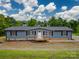 Newly built home with gray siding and a small deck at 55 Shannon Park Cir, Taylorsville, NC 28681