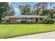 Brick ranch house with a well-maintained lawn at 1532 Downs Ave, Charlotte, NC 28205