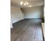 Living room with wood-look flooring, chandelier, and stairs at 1225 Dodd St, Shelby, NC 28152