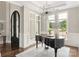Bright living room featuring a grand piano, large windows, and a modern chandelier at 514 Billy Howey Rd, Waxhaw, NC 28173