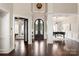 Elegant two-story entryway with dark hardwood floors, a statement chandelier, and arched double doors at 514 Billy Howey Rd, Waxhaw, NC 28173