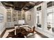 Bright home office with built-in shelving, hardwood floors, and a view of a private courtyard at 514 Billy Howey Rd, Waxhaw, NC 28173