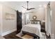Charming bedroom with a queen bed, dark wood floors, and barn door at 514 Billy Howey Rd, Waxhaw, NC 28173