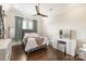 Bright bedroom with a queen bed, vanity, and wood floors at 514 Billy Howey Rd, Waxhaw, NC 28173