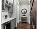 Functional butler's pantry with gray cabinetry, quartz countertops, and a herringbone backsplash at 514 Billy Howey Rd, Waxhaw, NC 28173