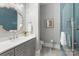 Bathroom with gray vanity, blue tile shower, and decorative mirror at 514 Billy Howey Rd, Waxhaw, NC 28173