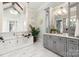 Elegant bathroom with a soaking tub, marble tile, and gray custom cabinetry at 514 Billy Howey Rd, Waxhaw, NC 28173