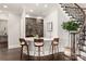 Custom wet bar with wine storage, a curved counter, and mid-century modern barstools at 514 Billy Howey Rd, Waxhaw, NC 28173