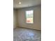 Bedroom with a window and new carpet at 1483 Honey Trl, Monroe, NC 28112