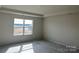 Bright bedroom with a large window and neutral walls at 1483 Honey Trl, Monroe, NC 28112