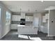 Modern kitchen with white cabinets and island at 1483 Honey Trl, Monroe, NC 28112