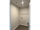 Laundry room with wire shelving and vinyl flooring at 1483 Honey Trl, Monroe, NC 28112