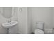 Powder room with pedestal sink, round mirror, and toilet at 6007 Mariemont Cir # 101, Charlotte, NC 28226