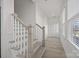 Staircase with white railing and wood-look stairs and flooring in a hallway at 6007 Mariemont Cir # 101, Charlotte, NC 28226