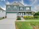 Two-story house featuring a blue exterior, two-car garage, and a landscaped front yard at 209 Meyers Ridge Rd, Cramerton, NC 28032