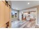 Open living room with sliding barn door and view of kitchen at 32548 Buchanan Ln, Albemarle, NC 28001