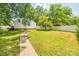 Spacious backyard with a large grassy area, a walkway, and a white fence at 300 Congress N St, York, SC 29745