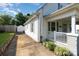 House exterior featuring a front porch, driveway, and detached shed at 205 Martin Luther King Jr Ave, Salisbury, NC 28144