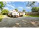 Rear view of house showcasing a deck and spacious concrete driveway at 205 Martin Luther King Jr Ave, Salisbury, NC 28144