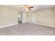 Primary bedroom with neutral walls, carpet, and two doors at 205 Martin Luther King Jr Ave, Salisbury, NC 28144