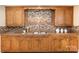 Well-maintained kitchen with wood cabinets and tile backsplash at 205 Martin Luther King Jr Ave, Salisbury, NC 28144