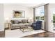 Bright living room features a comfy sofa, armchair, and coffee table at 8009 Elevate Ct, Charlotte, NC 28205