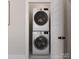 Stackable washer and dryer in a well-lit laundry closet at 8009 Elevate Ct, Charlotte, NC 28205