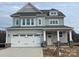 Charming two-story home with a welcoming front porch and attached two-car garage at 4808 Glen Stripe Dr # Cal0036, Indian Trail, NC 28079