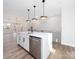 Modern kitchen with white cabinets, quartz countertops, and stainless steel appliances at 8009 Elevate Ct, Charlotte, NC 28205