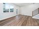 Light-filled living area featuring hardwood floors and access to balcony at 8009 Elevate Ct, Charlotte, NC 28205
