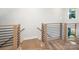 Modern staircase and upper landing with wood flooring and metal railing at 8009 Elevate Ct, Charlotte, NC 28205