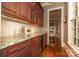 Butlers pantry with granite countertops and ample storage at 3318 Indian Meadows Ln, Charlotte, NC 28210