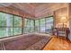 Sunroom with wood ceiling, large windows, and wooded views at 8 Blackberry Ln, Lake Wylie, SC 29710