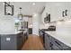 Modern kitchen with stainless steel appliances and two-toned cabinetry at 14048 Lake Home Ln, Charlotte, NC 28278