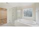 Spa-like bathroom with soaking tub, shower, and window at 5304 Verona Rd # 76, Charlotte, NC 28213