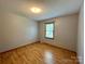 Simple bedroom with hardwood floors and window at 2232 Stallings Rd, Matthews, NC 28104