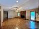 Spacious living room with hardwood floors, brick fireplace, and access to deck at 2232 Stallings Rd, Matthews, NC 28104