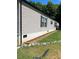 Side view of mobile home with landscaping at 960 E 1St St, Newton, NC 28658