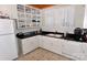 Galley kitchen with white cabinets, granite countertops and a double sink at 522 Maupin Ave, Salisbury, NC 28144