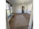 Bright living room with large windows and carpeted floors at 203 N Meriah St, Landis, NC 28088